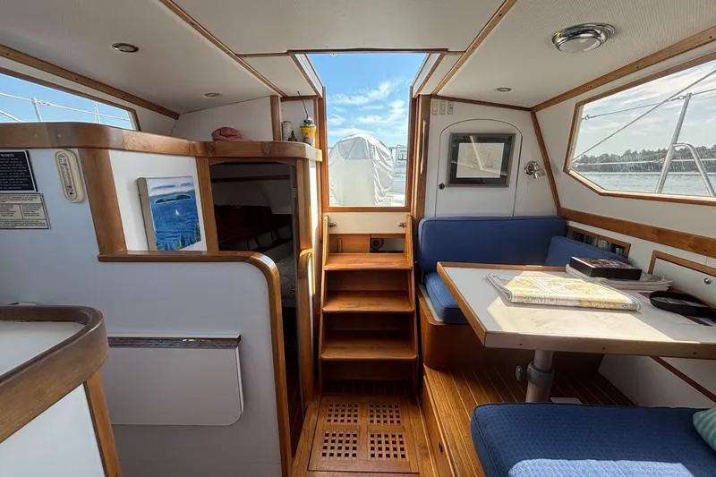 Custom Yacht Photos Pics Interior of a 2000 Sabre 452 yacht with wooden accents and blue seating.