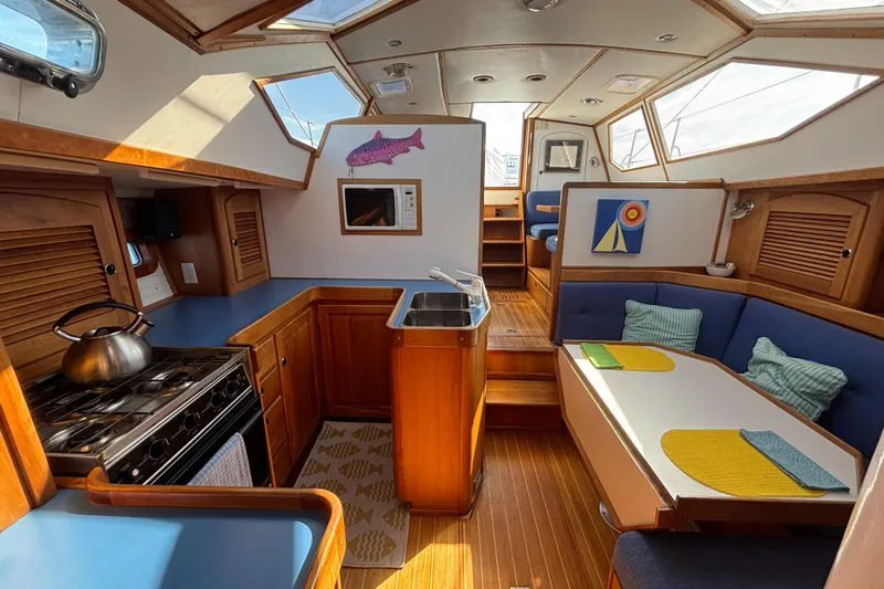 Custom Yacht Photos Pics Interior of 2000 Sabre 452 sailboat with kitchen, dining area, and wooden finishes.