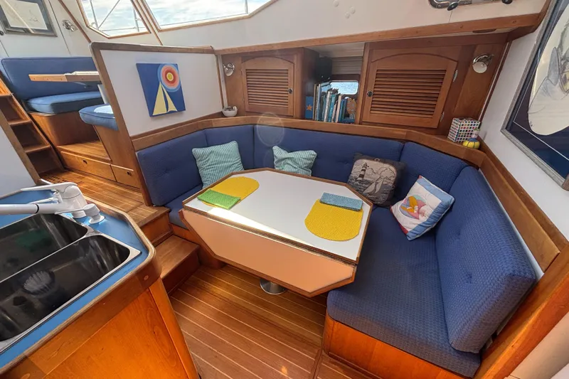 Custom Yacht Photos Pics Cozy interior of 2000 Sabre 452 yacht with blue seating and wooden accents.