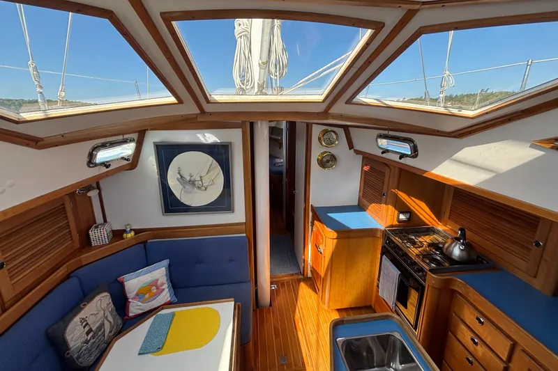 Custom Yacht Photos Pics Interior of a 2000 Sabre 452 sailboat with skylights, kitchen, and seating area.
