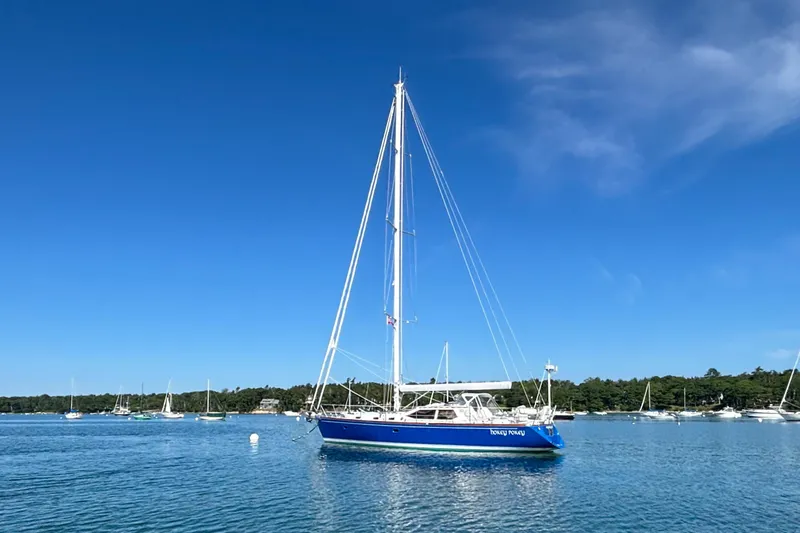 Custom Yacht Photos Pics Sailboat Sabre 452 (2000) on calm water under clear blue sky.