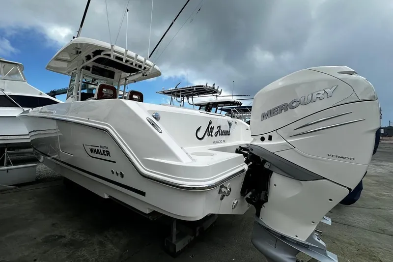  Yacht Photos Pics 2017 Boston Whaler 330 Outrage with Mercury Verado engine, docked under cloudy sky.