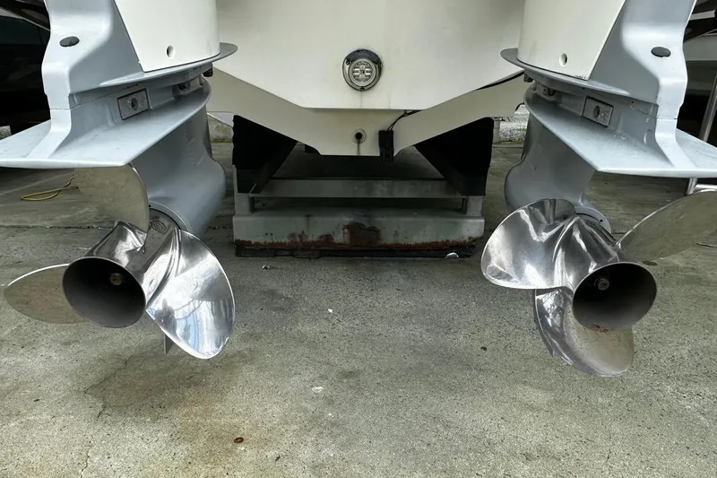  Yacht Photos Pics Twin propellers of a 2017 Boston Whaler 330 Outrage on concrete surface.