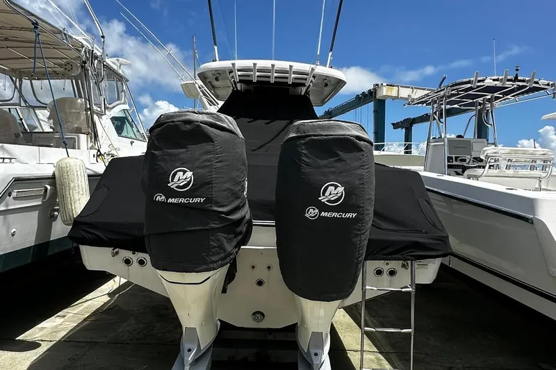  Yacht Photos Pics 2017 Boston Whaler 330 Outrage with Mercury engines, docked under clear blue sky.