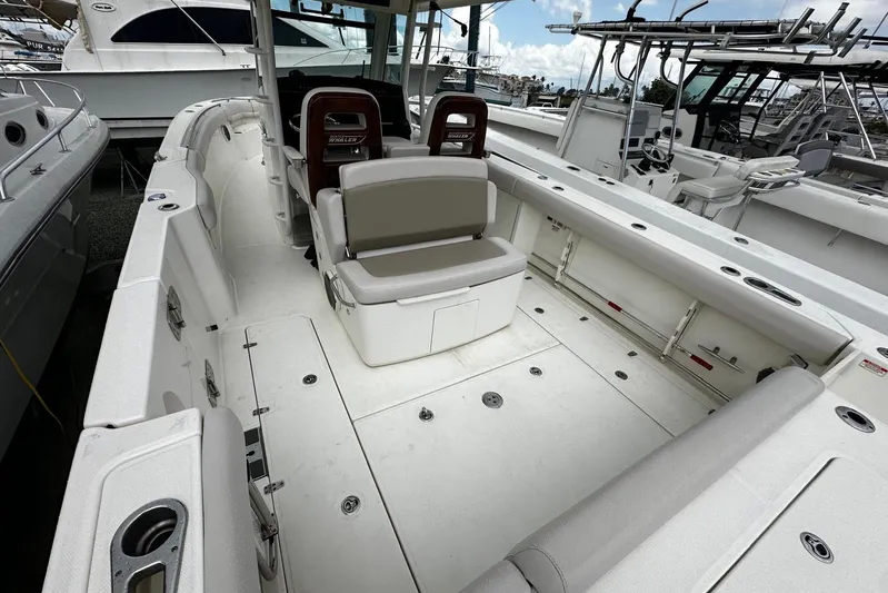  Yacht Photos Pics 2017 Boston Whaler 330 Outrage boat interior with seating and storage compartments.