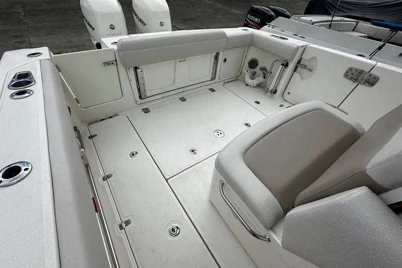  Yacht Photos Pics 2017 Boston Whaler 330 Outrage boat interior with seating and storage compartments.