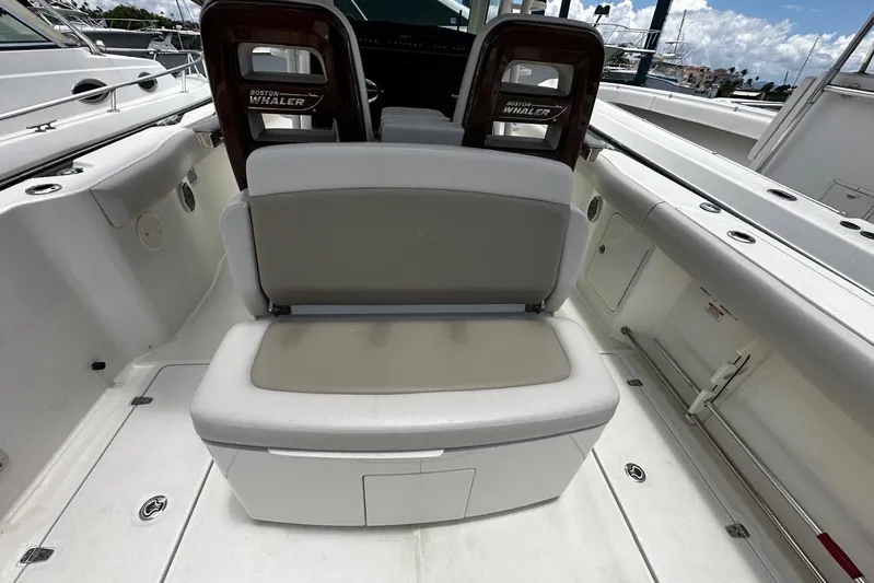  Yacht Photos Pics 2017 Boston Whaler 330 Outrage boat interior with seating and storage.