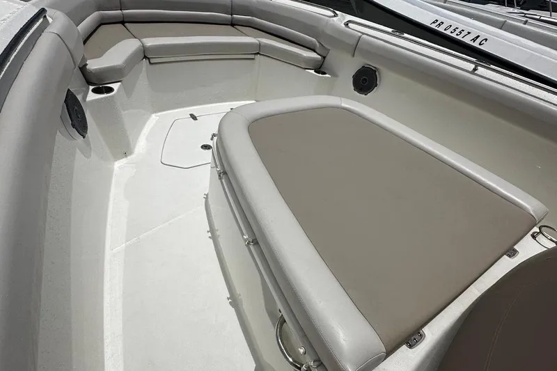  Yacht Photos Pics 2017 Boston Whaler 330 Outrage boat interior with cushioned seating and storage.
