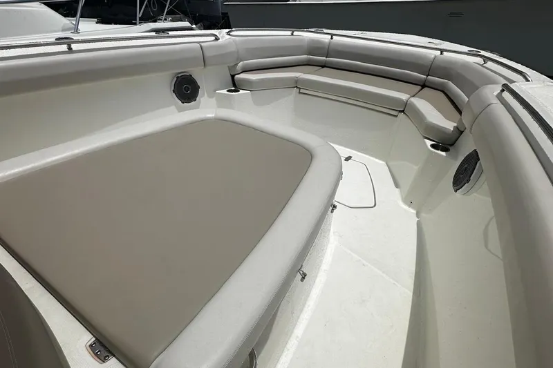  Yacht Photos Pics 2017 Boston Whaler 330 Outrage boat interior with cushioned seating and speakers.