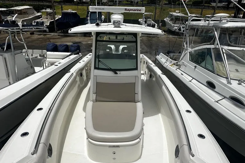  Yacht Photos Pics 2017 Boston Whaler 330 Outrage boat docked, featuring spacious seating and modern design.
