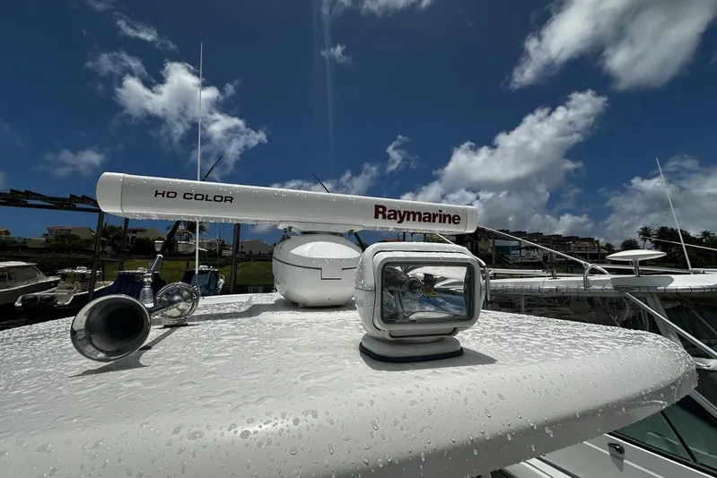  Yacht Photos Pics 2017 Boston Whaler 330 Outrage with Raymarine radar and spotlight under a clear sky.