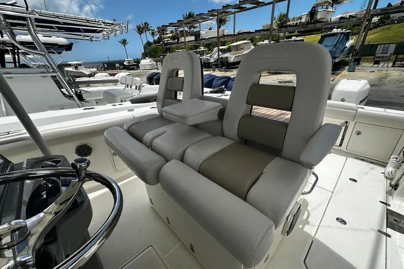  Yacht Photos Pics 2017 Boston Whaler 330 Outrage boat interior with plush seating and steering wheel.