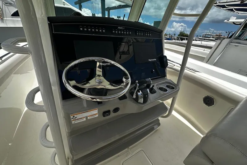  Yacht Photos Pics 2017 Boston Whaler 330 Outrage helm with steering wheel and Raymarine electronics.