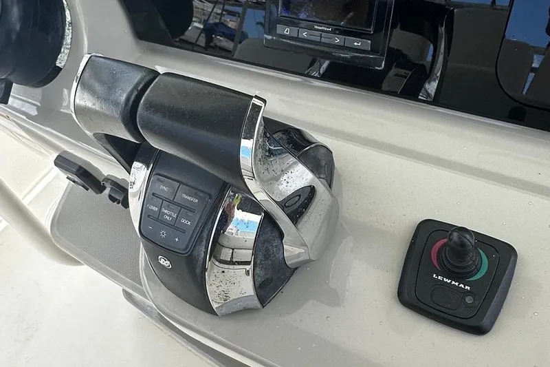  Yacht Photos Pics Control panel of a 2017 Boston Whaler 330 Outrage boat, featuring throttle and joystick.