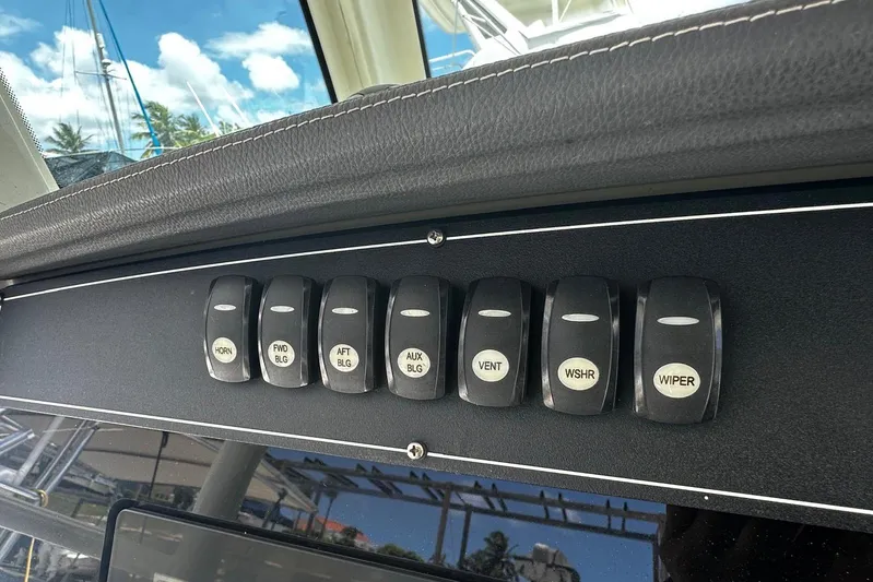 Yacht Photos Pics Control panel switches on a 2017 Boston Whaler 330 Outrage boat dashboard.