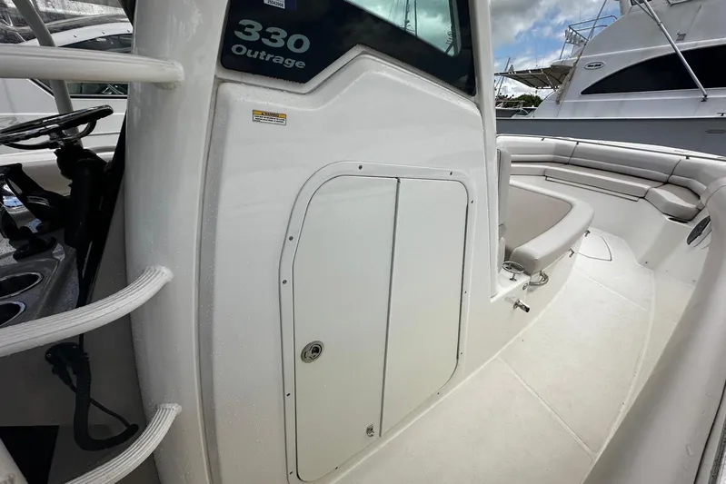  Yacht Photos Pics 2017 Boston Whaler 330 Outrage boat interior with seating and storage compartment.
