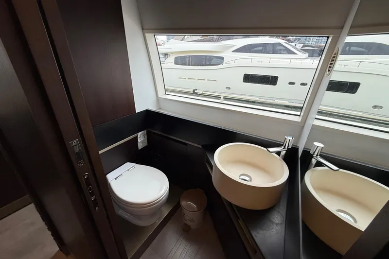 Ferretti 850 Yacht Photos Pics Luxurious bathroom on a 2017 Ferretti Yachts 850 with modern fixtures and large window view.