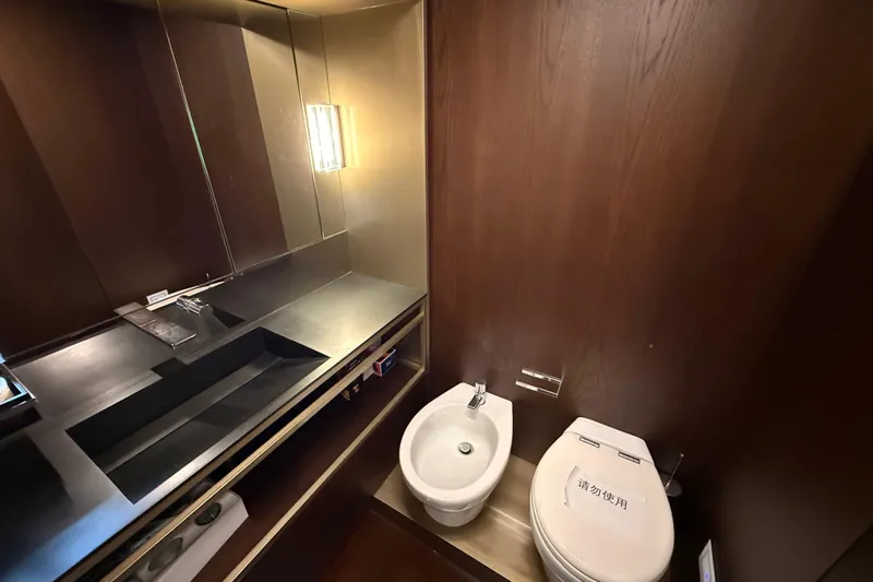 Ferretti 850 Yacht Photos Pics Luxurious bathroom in 2017 Ferretti Yachts 850, featuring modern fixtures and elegant wood paneling.