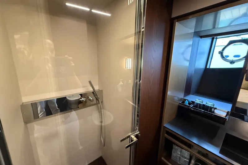 Ferretti 850 Yacht Photos Pics Luxurious bathroom interior of 2017 Ferretti Yachts 850 with modern fixtures and porthole window.