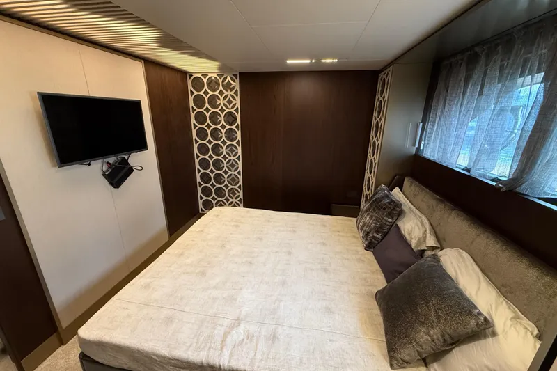 Ferretti 850 Yacht Photos Pics Luxurious bedroom interior of 2017 Ferretti Yachts 850 with modern decor and TV.