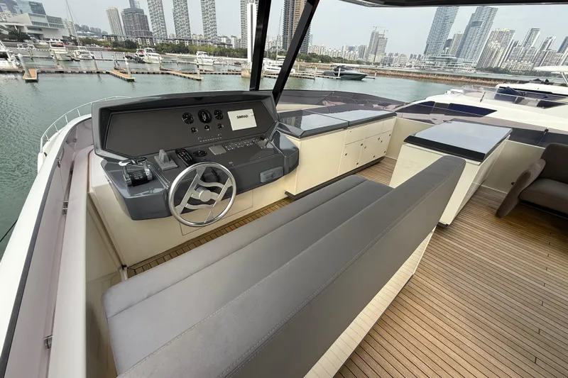 Ferretti 850 Yacht Photos Pics Luxurious 2017 Ferretti Yachts 850 helm with modern controls, overlooking marina and city skyline.
