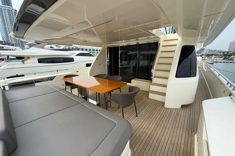 Ferretti 850 Yacht Photos Pics Luxurious 2017 Ferretti Yachts 850 deck with seating and dining area, docked at marina.