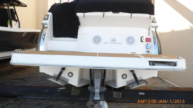  Yacht Photos Pics 2018 Regal 28 Express boat rear view with swim platform and outboard motor.