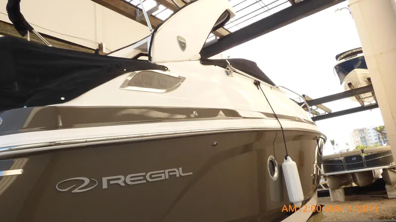  Yacht Photos Pics 2018 Regal 28 Express boat in storage, side view with logo visible.