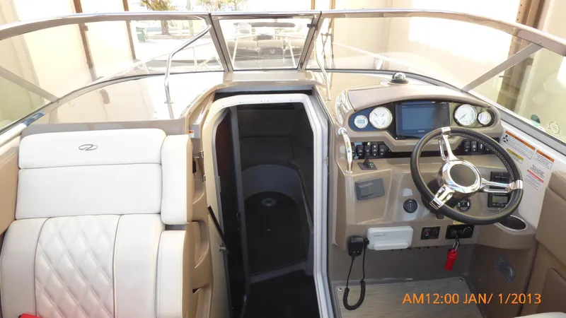  Yacht Photos Pics 2018 Regal 28 Express boat interior with steering wheel and cabin entrance.
