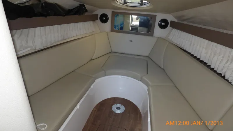  Yacht Photos Pics Interior of 2018 Regal 28 Express boat with beige seating and wood flooring.