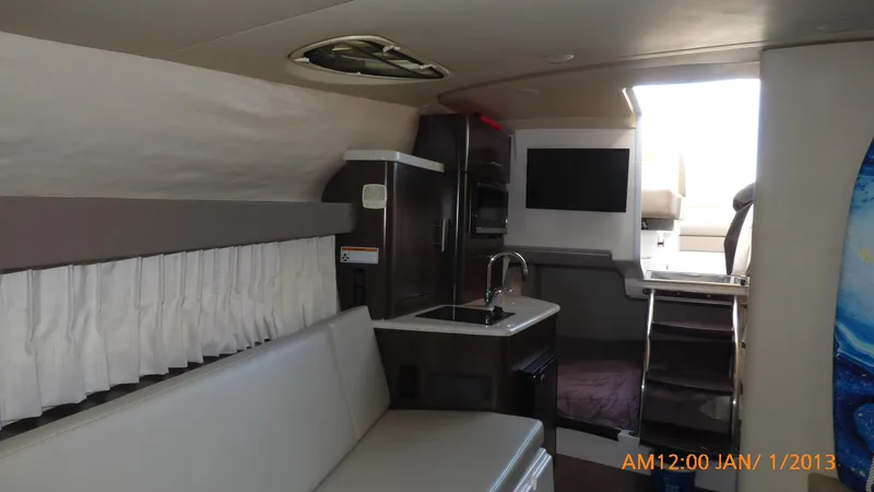  Yacht Photos Pics Interior of 2018 Regal 28 Express boat with kitchenette and seating area.