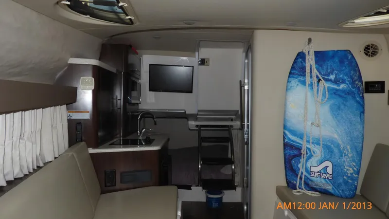  Yacht Photos Pics Interior of 2018 Regal 28 Express boat with kitchenette and surfboard.