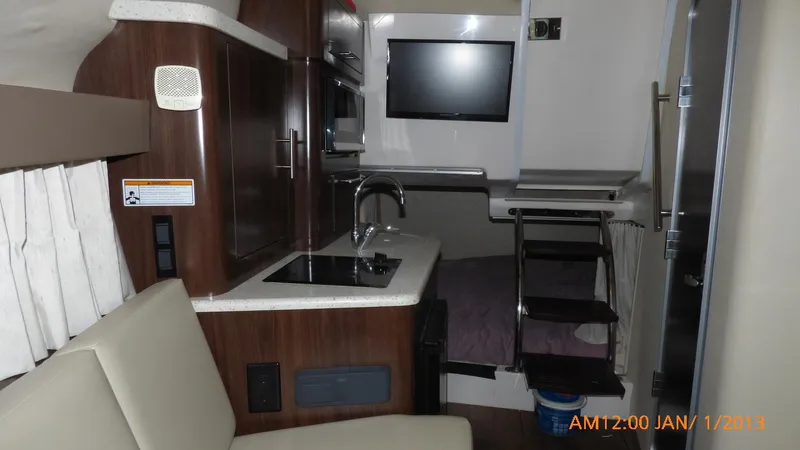  Yacht Photos Pics Interior of 2018 Regal 28 Express boat with kitchenette and seating area.