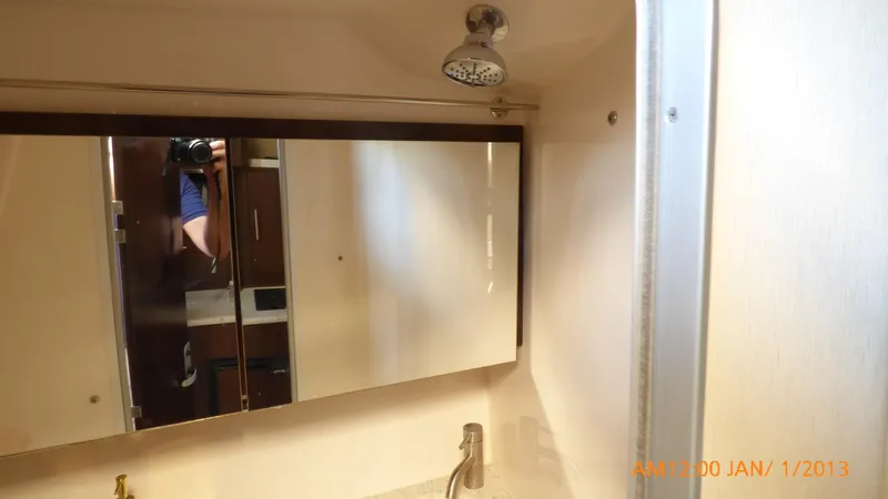  Yacht Photos Pics Bathroom interior of 2018 Regal 28 Express boat with mirror and faucet.