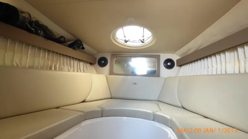  Yacht Photos Pics Interior cabin of 2018 Regal 28 Express boat with circular seating and porthole.