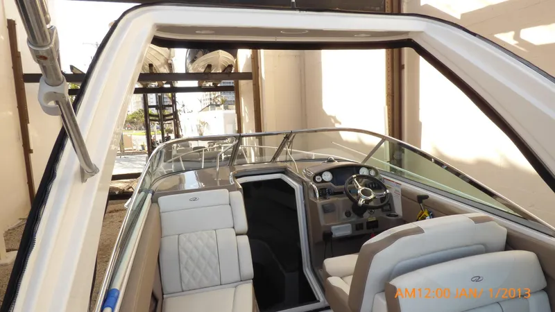  Yacht Photos Pics 2018 Regal 28 Express boat interior with steering wheel and seating.