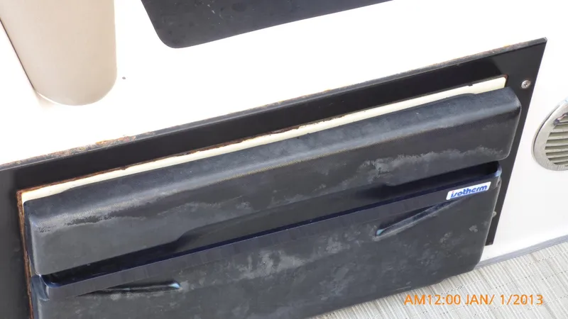  Yacht Photos Pics Close-up of a 2018 Regal 28 Express boat compartment with a black cover.