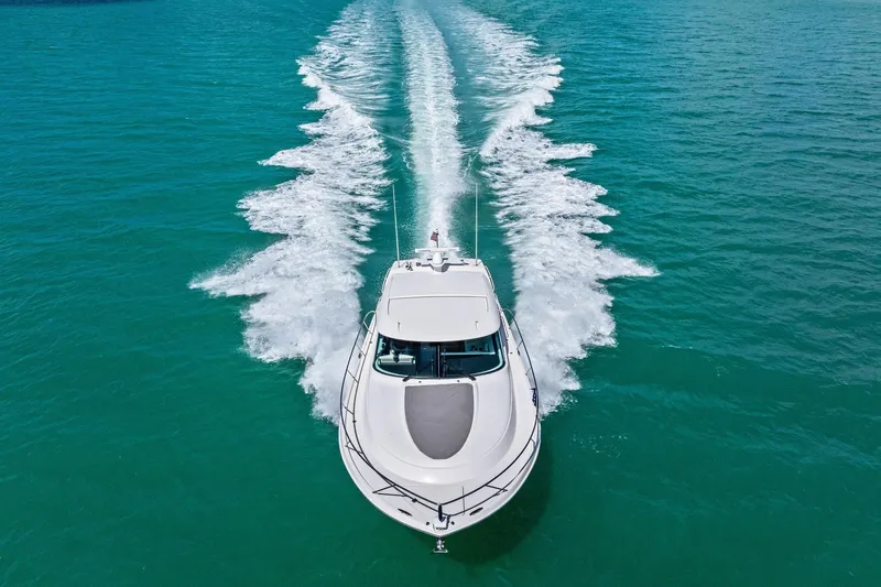 Southwind Yacht Photos Pics 2018 Tiara Yachts C44 Coupe cruising on turquoise water, aerial view.