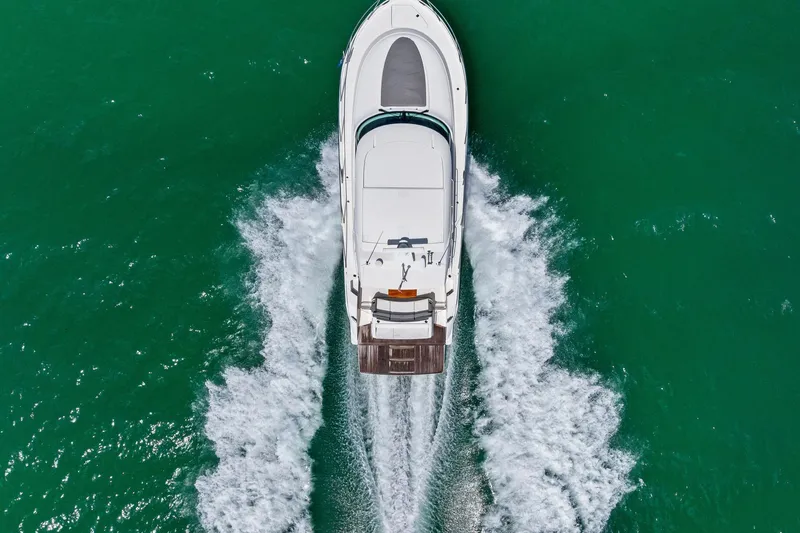Southwind Yacht Photos Pics Aerial view of 2018 Tiara Yachts C44 Coupe cruising on turquoise water.