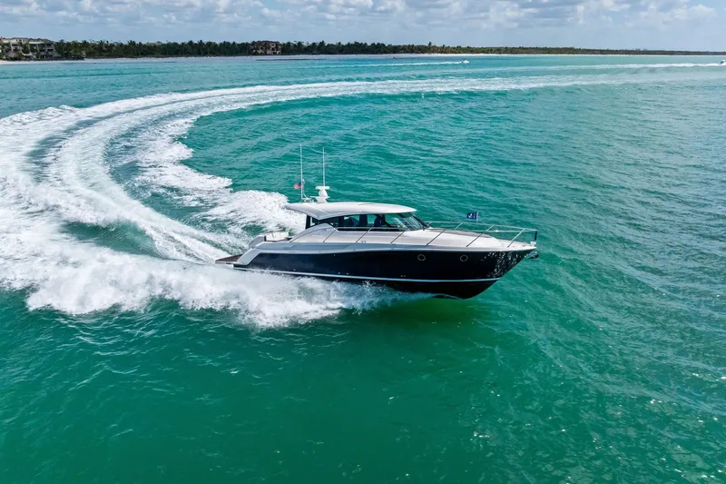 Southwind Yacht Photos Pics 2018 Tiara Yachts C44 Coupe cruising on turquoise waters, creating a dynamic wake.