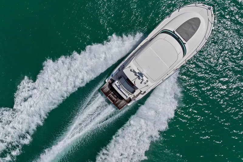 Southwind Yacht Photos Pics Aerial view of 2018 Tiara Yachts C44 Coupe cruising on turquoise water.