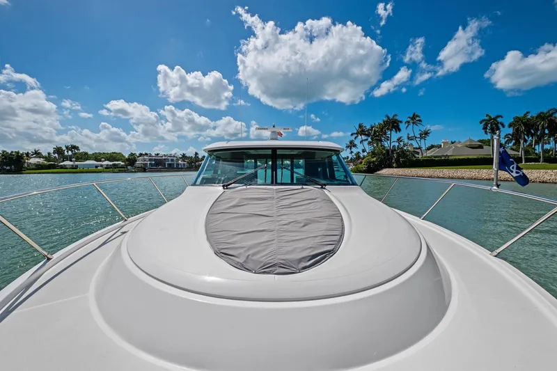 Southwind Yacht Photos Pics 2018 Tiara Yachts C44 Coupe on serene water, under a bright blue sky.