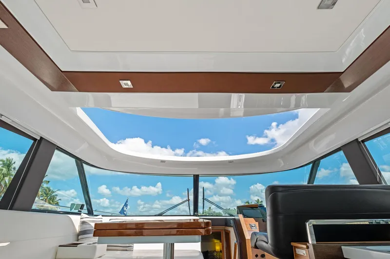 Southwind Yacht Photos Pics Interior view of 2018 Tiara Yachts C44 Coupe with open sunroof and blue sky.
