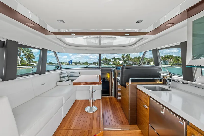 Southwind Yacht Photos Pics Luxurious interior of 2018 Tiara Yachts C44 Coupe with modern seating and kitchen area.