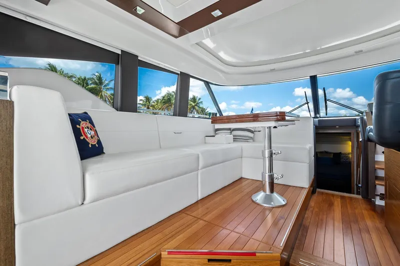 Southwind Yacht Photos Pics Luxurious interior of 2018 Tiara Yachts C44 Coupe with white seating and wooden flooring.