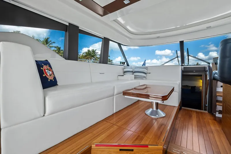 Southwind Yacht Photos Pics Luxurious interior of 2018 Tiara Yachts C44 Coupe with elegant seating and wooden flooring.