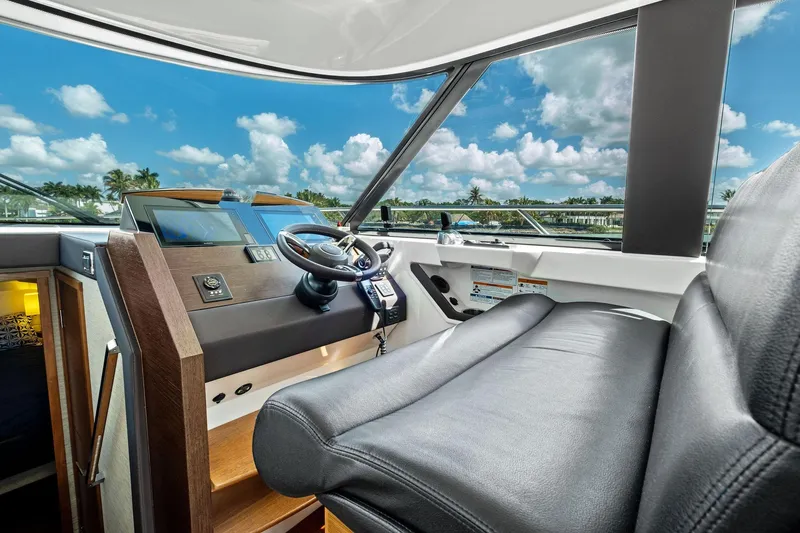 Southwind Yacht Photos Pics 2018 Tiara Yachts C44 Coupe helm with leather seating and modern controls, under a blue sky.