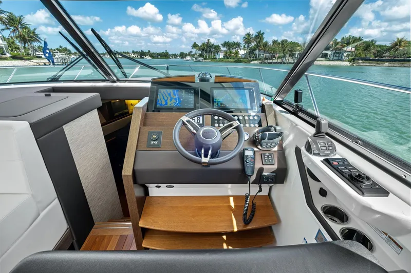 Southwind Yacht Photos Pics 2018 Tiara Yachts C44 Coupe helm with modern navigation equipment and scenic waterway view.