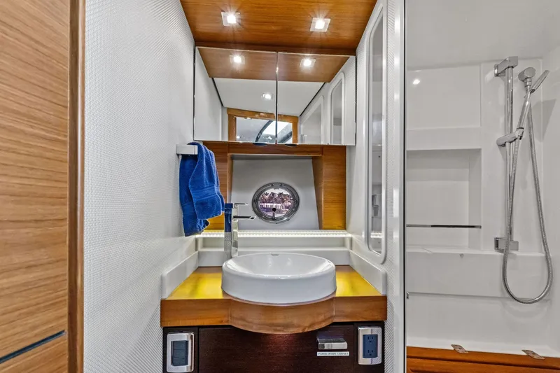 Southwind Yacht Photos Pics Luxurious bathroom in 2018 Tiara Yachts C44 Coupe with modern fixtures and elegant design.