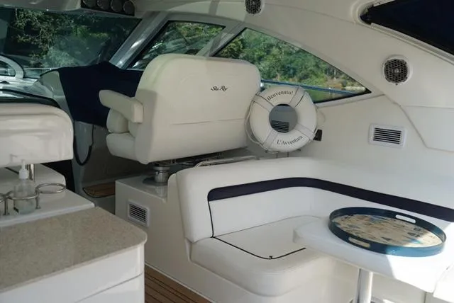 L' Aventura Yacht Photos Pics Interior of 2010 Sea Ray 470 Sundancer yacht with white seating and helm.